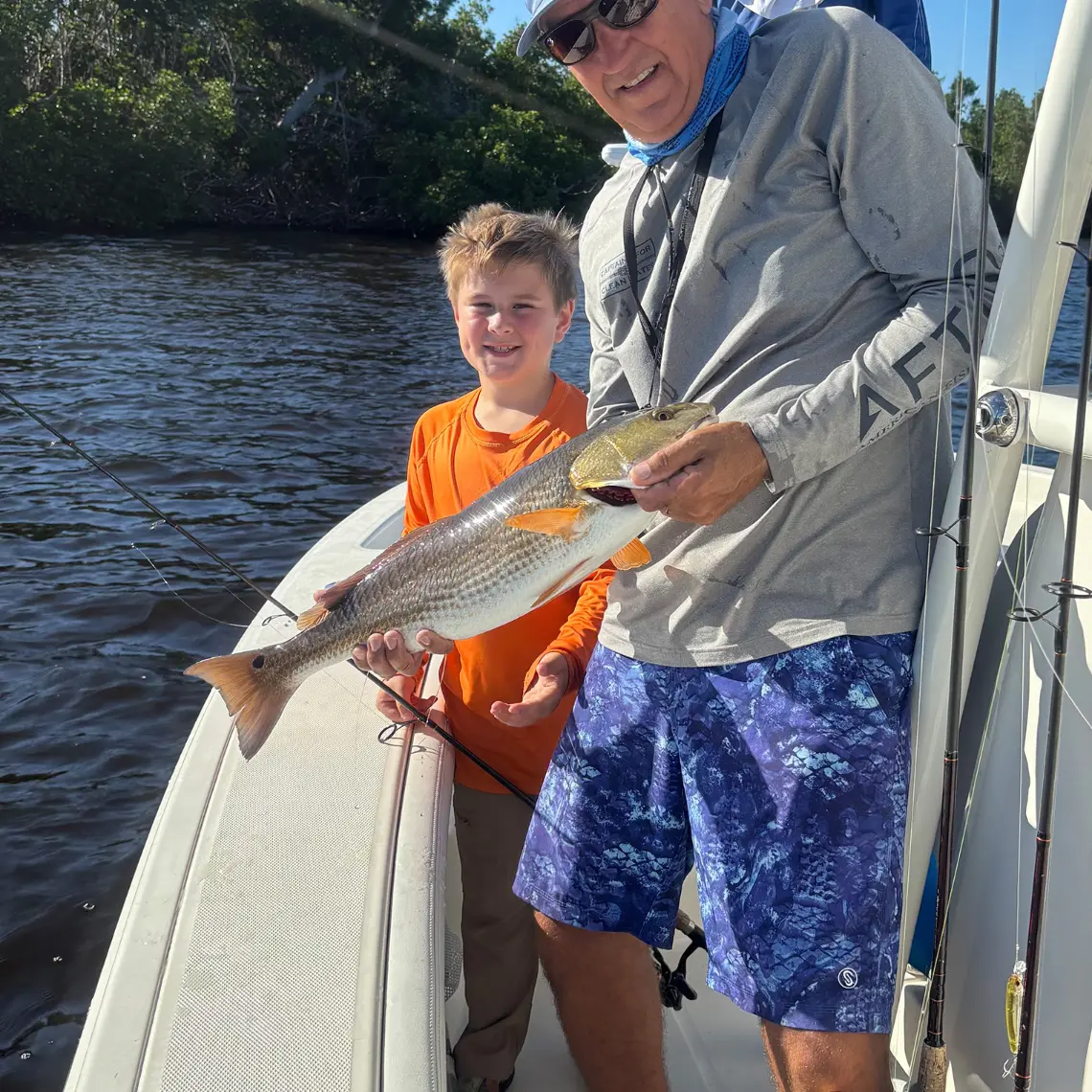 Young angler and Capt. Glenn holding a redfish caught in Charlotte Harbor